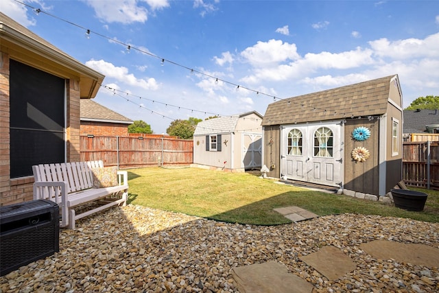 view of yard with a fenced backyard, an outdoor structure, and a shed