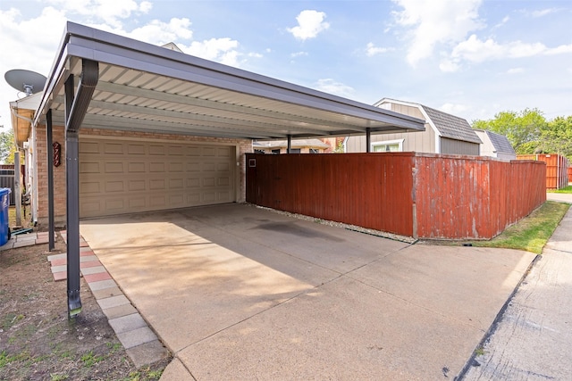 view of side of home featuring fence, concrete driveway, and brick siding