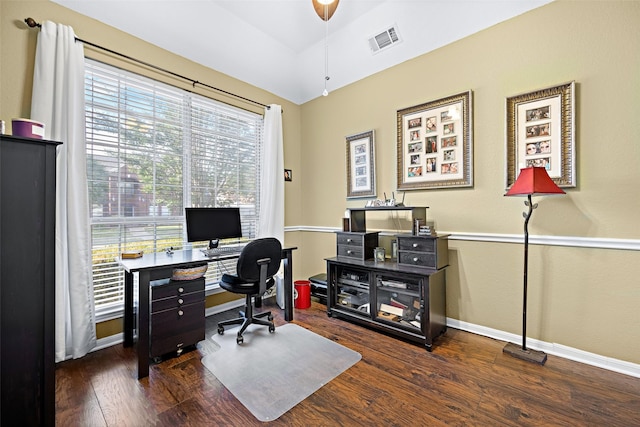 home office with lofted ceiling, dark wood-style flooring, visible vents, and baseboards