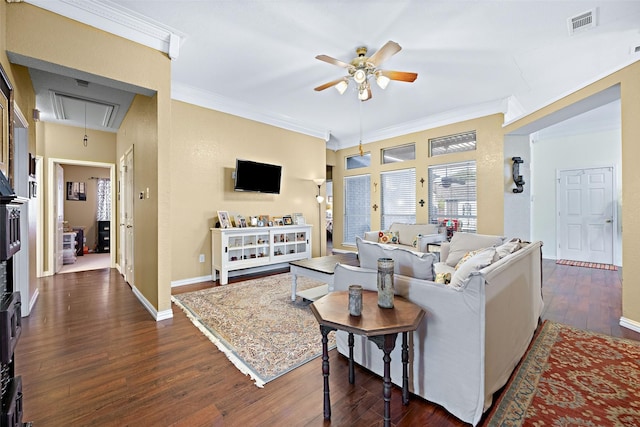 living room with attic access, baseboards, visible vents, dark wood-type flooring, and crown molding