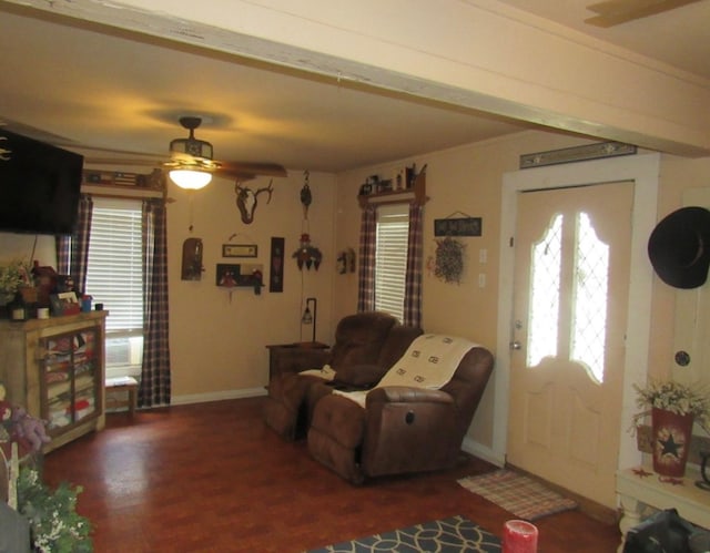 living room featuring hardwood / wood-style floors, ceiling fan, crown molding, and a healthy amount of sunlight