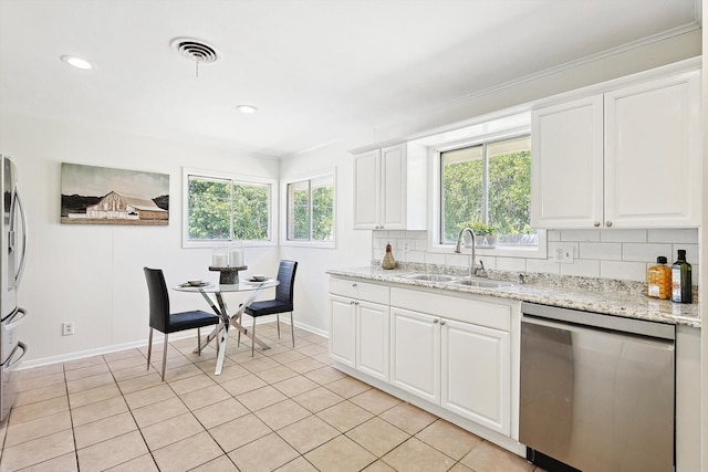 kitchen with white cabinetry, sink, stainless steel appliances, and tasteful backsplash