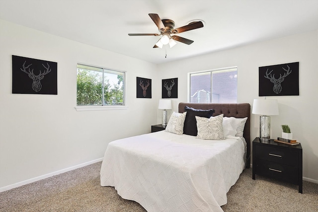 bedroom featuring light colored carpet and ceiling fan