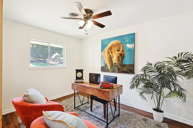 home office with ceiling fan and dark hardwood / wood-style floors