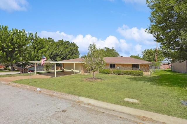 ranch-style home featuring a carport, a front yard, and brick siding