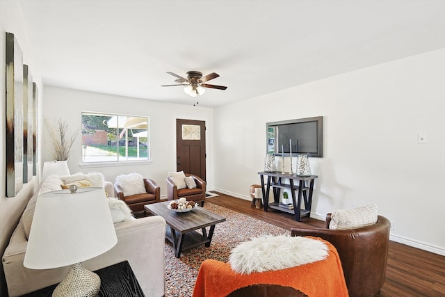 living room with dark hardwood / wood-style flooring and ceiling fan