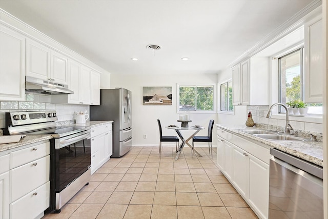 kitchen featuring decorative backsplash, light tile patterned floors, white cabinetry, and stainless steel appliances