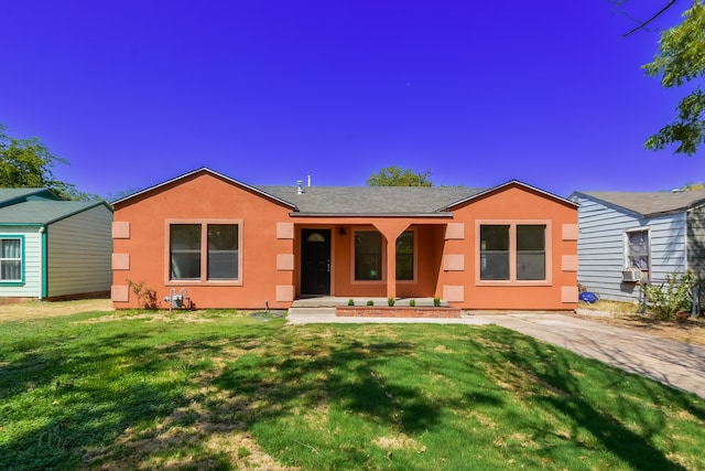 ranch-style home with a front lawn