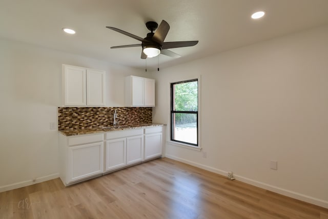 interior space with light hardwood / wood-style floors, sink, and ceiling fan