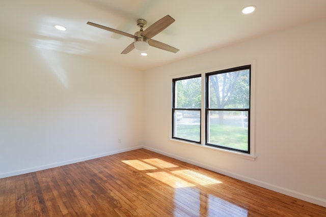 unfurnished room with hardwood / wood-style flooring and ceiling fan