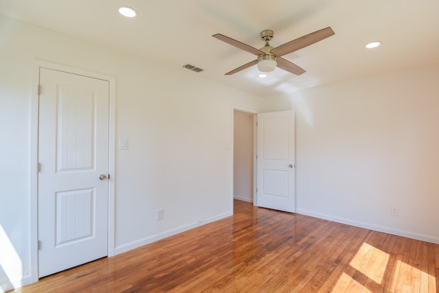 unfurnished room with ceiling fan and hardwood / wood-style floors