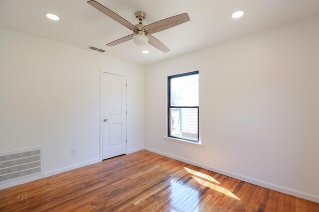 empty room with ceiling fan and light wood-type flooring