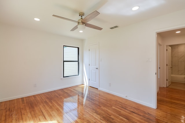 spare room featuring ceiling fan and light hardwood / wood-style flooring