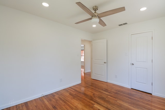 unfurnished bedroom with ceiling fan and hardwood / wood-style floors