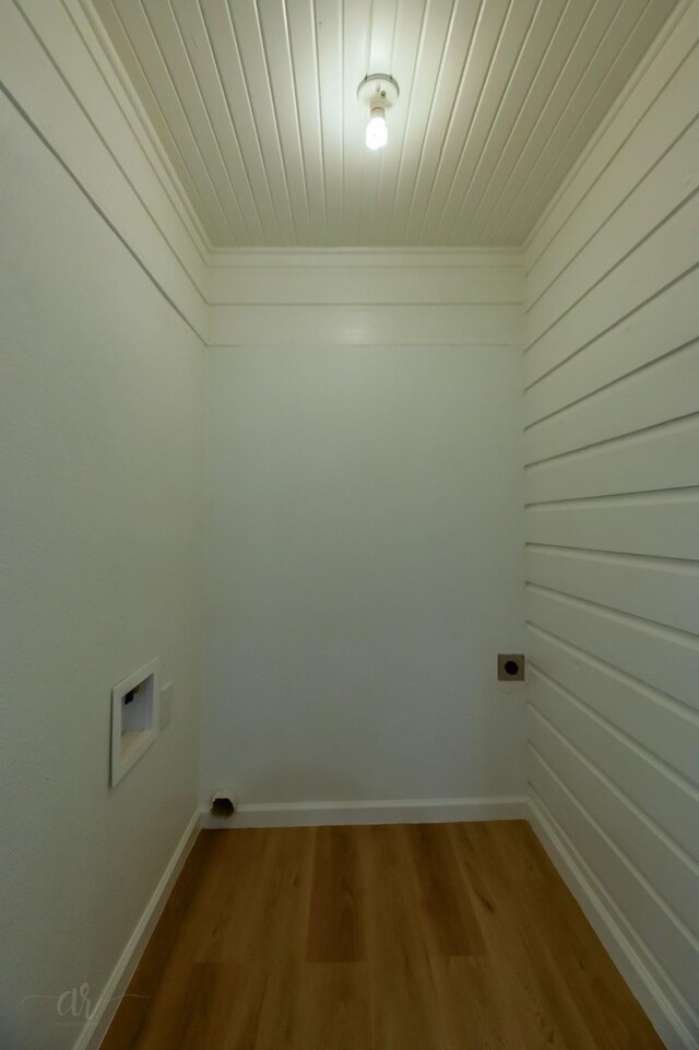 laundry room featuring washer hookup, electric dryer hookup, ornamental molding, and wood-type flooring