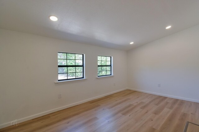 empty room with light hardwood / wood-style floors