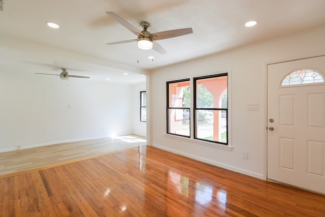 foyer entrance featuring ceiling fan, light hardwood / wood-style flooring, and a healthy amount of sunlight