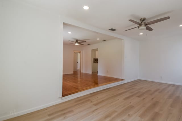 unfurnished room featuring ceiling fan and light wood-type flooring