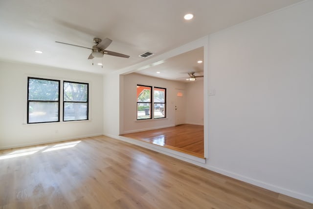 empty room featuring ceiling fan and light hardwood / wood-style flooring