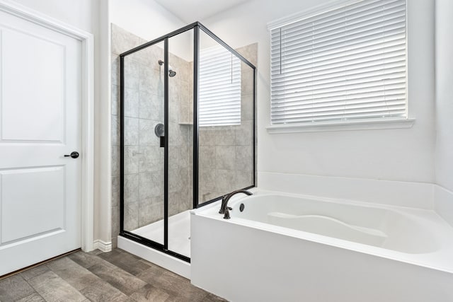 bathroom with hardwood / wood-style flooring and plus walk in shower