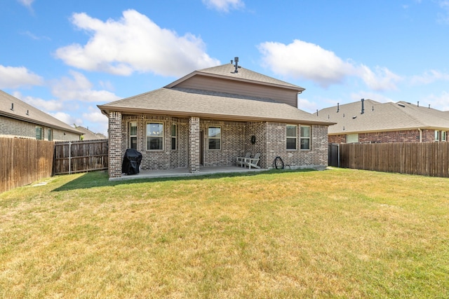 back of property featuring a patio, brick siding, a lawn, and a fenced backyard