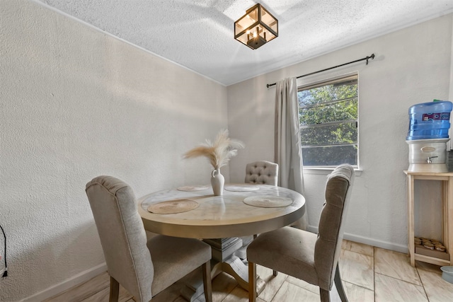 tiled dining room with a textured ceiling