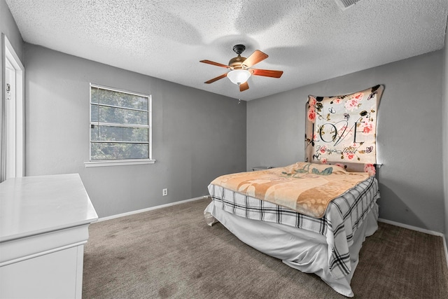 carpeted bedroom with ceiling fan and a textured ceiling