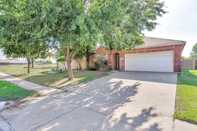 obstructed view of property with a front yard and a garage