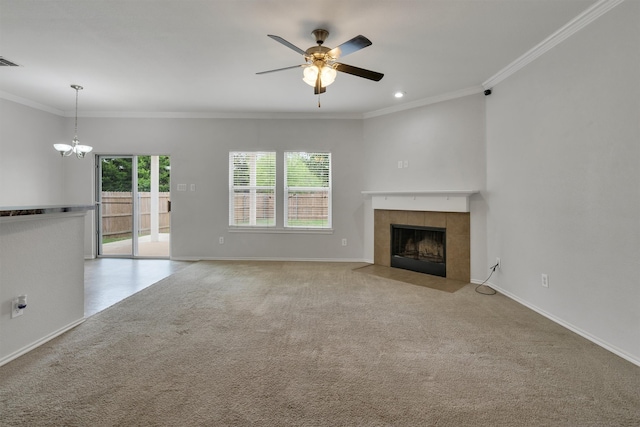 unfurnished living room featuring crown molding, a fireplace, light carpet, and ceiling fan with notable chandelier