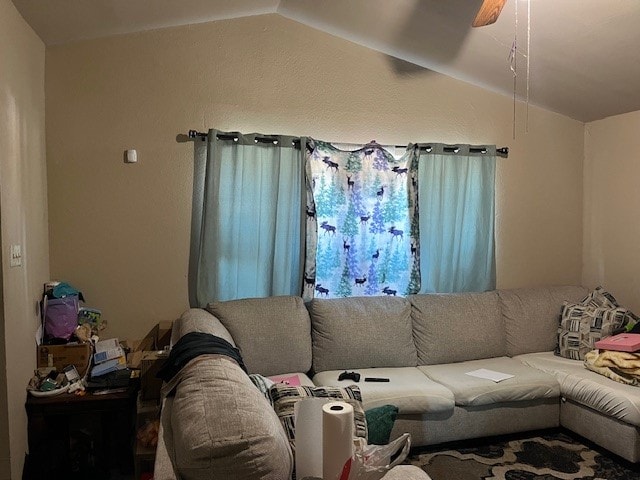 living room with ceiling fan and lofted ceiling