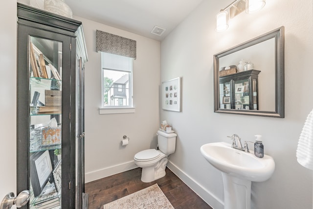 bathroom featuring hardwood / wood-style flooring and toilet