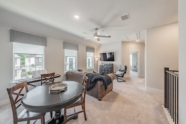 carpeted dining room featuring ceiling fan