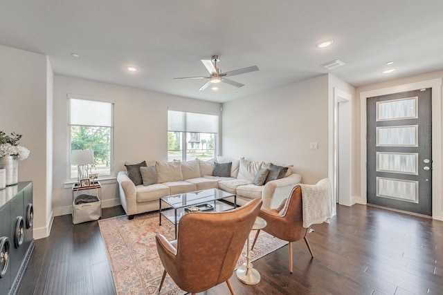 living room featuring ceiling fan and dark hardwood / wood-style flooring