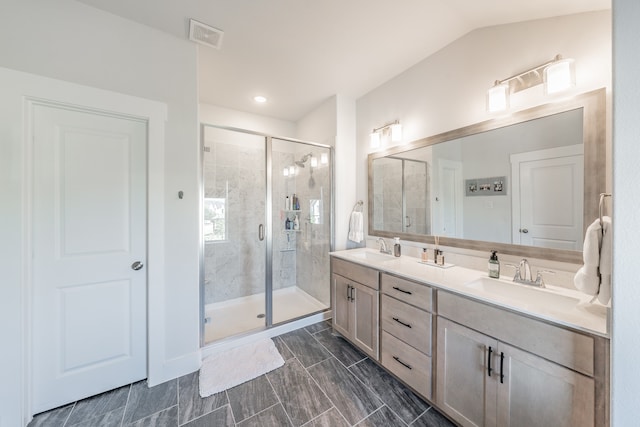 bathroom with tile patterned floors, an enclosed shower, vaulted ceiling, and vanity