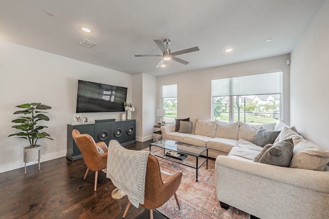 living room with ceiling fan and dark wood-type flooring