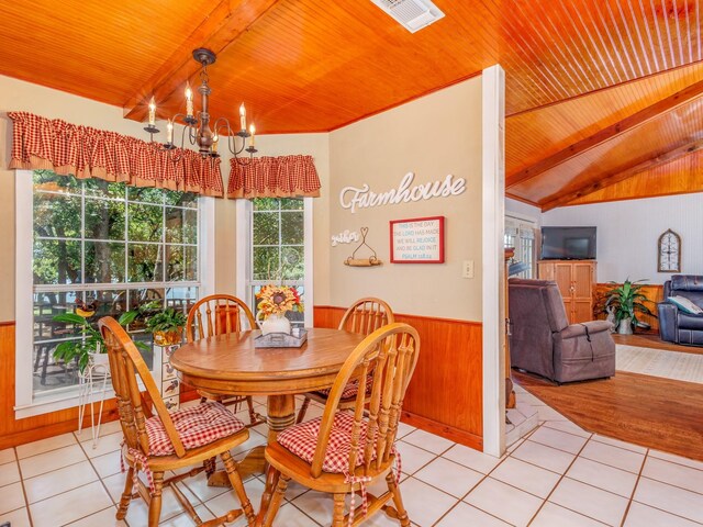 tiled dining room with wood ceiling, vaulted ceiling with beams, and an inviting chandelier