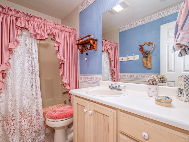 bathroom featuring shower / tub combo, vanity, and toilet