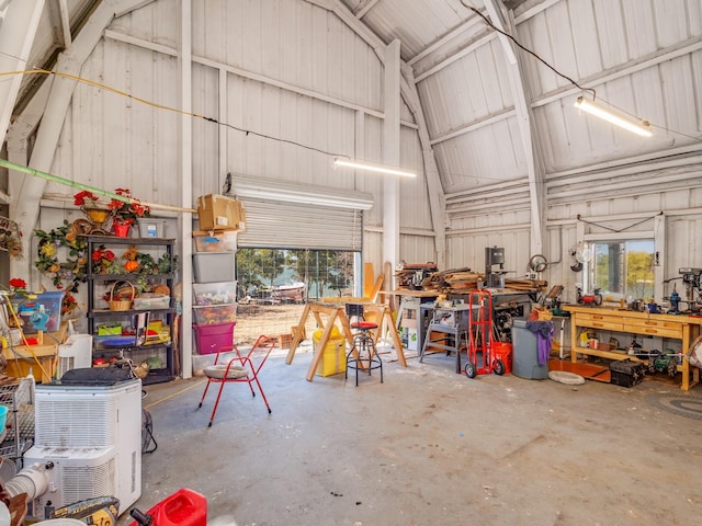 garage with a workshop area and metal wall