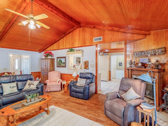 living room featuring ceiling fan, light hardwood / wood-style floors, wooden ceiling, and lofted ceiling with beams