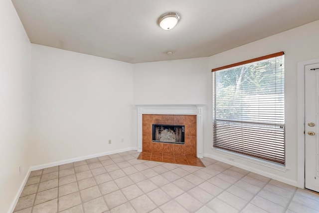 unfurnished living room featuring a fireplace and light tile patterned floors