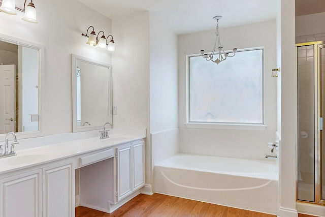 bathroom with hardwood / wood-style floors, a healthy amount of sunlight, vanity, and separate shower and tub