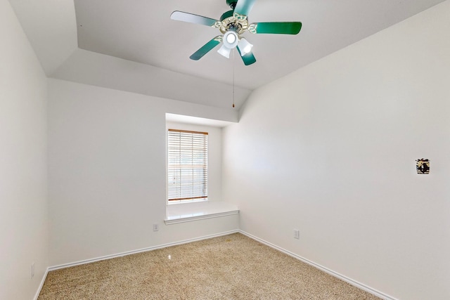 carpeted spare room featuring ceiling fan and lofted ceiling