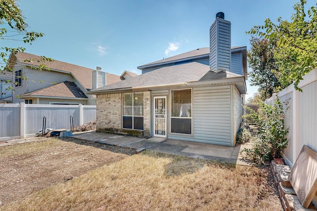 back of house with a patio