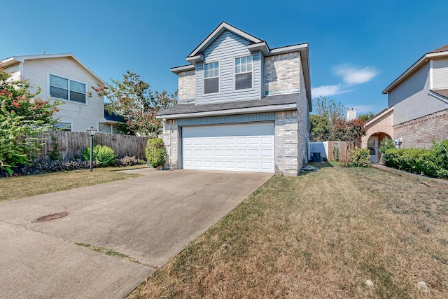 view of front property featuring a garage and a front lawn