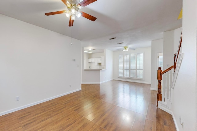 unfurnished living room featuring light wood-type flooring and ceiling fan