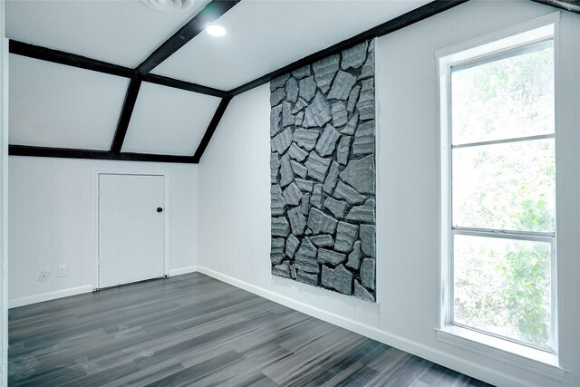 bonus room with vaulted ceiling with beams, hardwood / wood-style floors, and a wealth of natural light