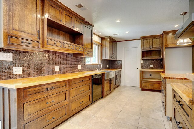 kitchen featuring butcher block countertops, backsplash, and decorative light fixtures