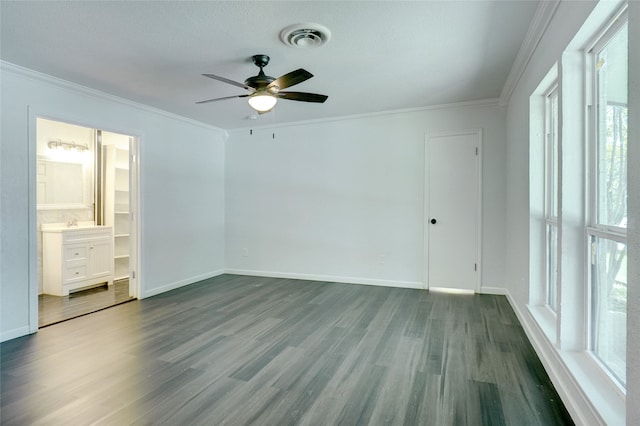 unfurnished bedroom with ceiling fan, hardwood / wood-style floors, connected bathroom, and crown molding