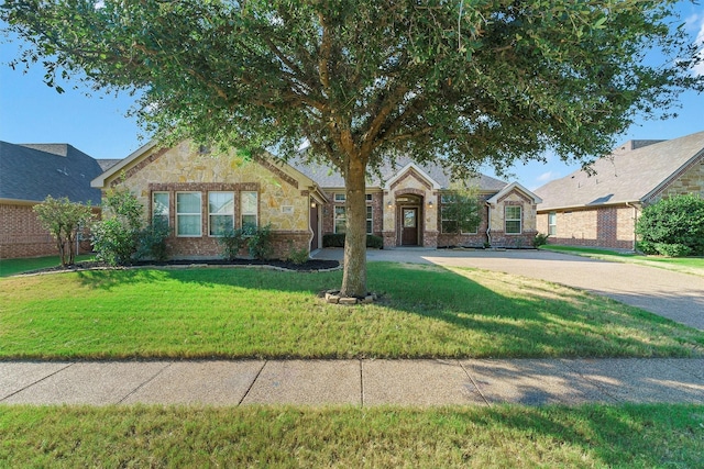 ranch-style home with stone siding, a front lawn, and brick siding