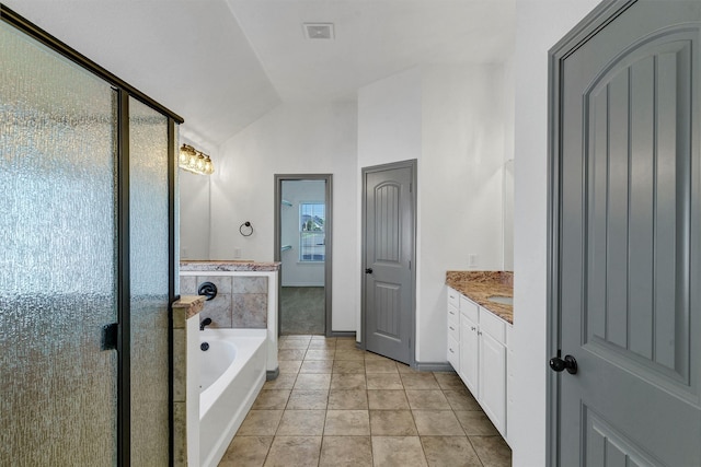 bathroom featuring tile patterned floors, separate shower and tub, vanity, and lofted ceiling